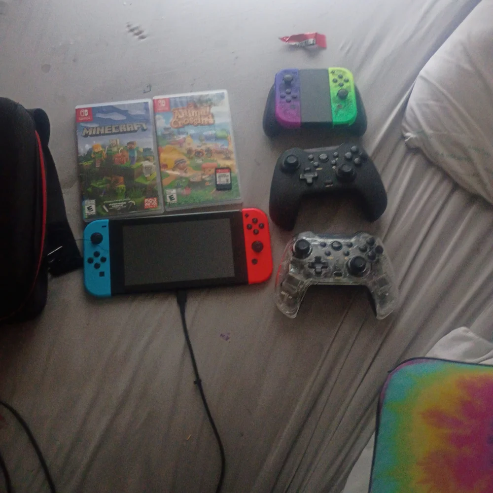 Nintendo Switch with Red and Blue Joy-Con and Multicolor Controllers